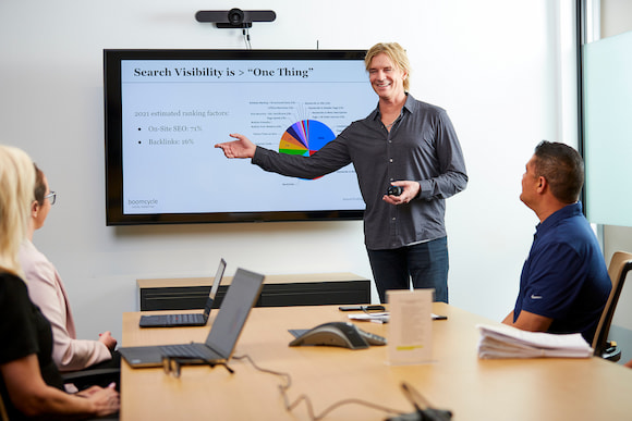 David Victor presenting search visibility SEO strategy to clients in conference room