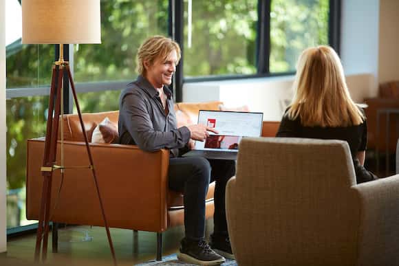 David Victor consulting with client on digital marketing strategy in modern office