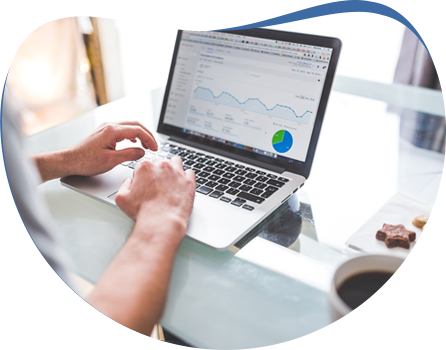 Digital marketer reviewing analytics dashboard on laptop at desk