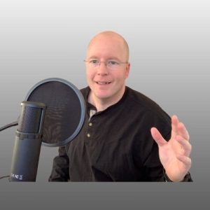 Christoph Trappe speaking into professional microphone in studio setting