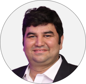 Hitesh Bhasin professional headshot in circular frame wearing black blazer