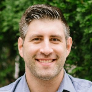 Jay Acunzo, speaker and marketing expert, smiling outdoors