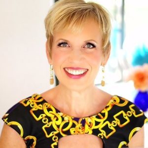 Mari Smith professional headshot wearing yellow and black patterned top