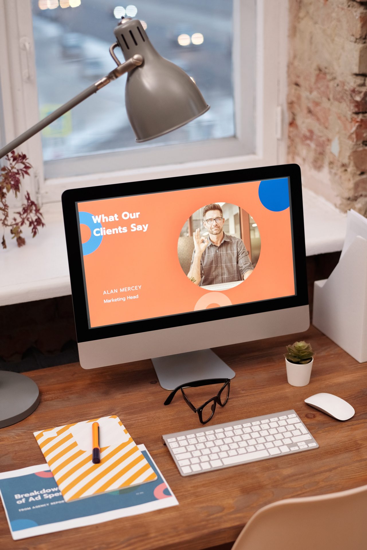 Desktop display showing "What Our Clients Say" testimonial with Alan Mercey, Marketing Head, on orange background