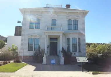 Historic white Victorian house with columns and balcony in San Ramon