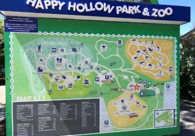 Happy Hollow Park & Zoo outdoor map and directory sign with colored sections and attraction icons