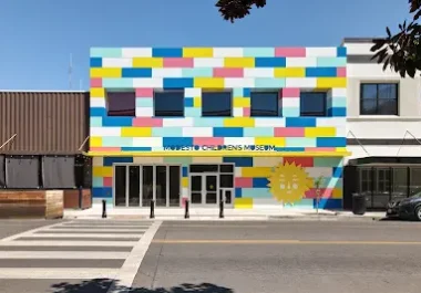 Modesto Children's Museum building with colorful block-pattern facade and sun mural