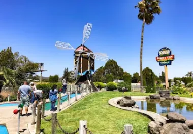 Scandia Family Fun Center windmill and mini golf course in Fairfield with palm tree and clear sky