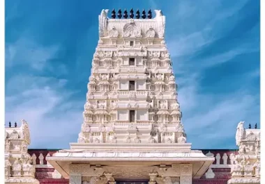 Shiva Vishnu Temple in Livermore with ornate white stone tower and red pillars