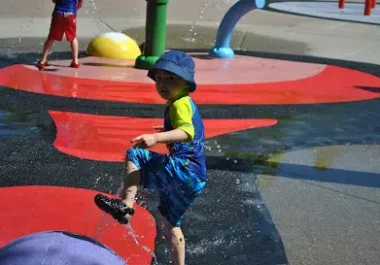 Child playing on red obstacle course at Danville park