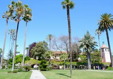 Mission Santa Clara garden with palm trees and green lawn in Sunnyvale