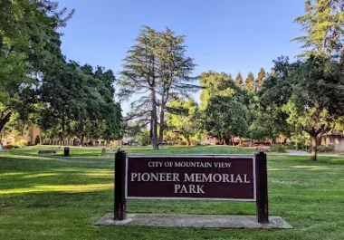 Pioneer Memorial Park sign in Mountain View with mature trees and green lawn