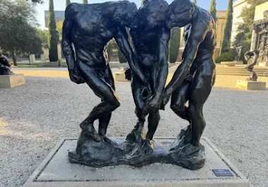 Three bronze figures in abstract form, outdoor sculpture installation